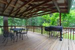 Covered deck with large trees to give you a more private feel.